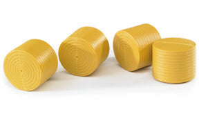 A group of four ochre brown round toy hay bales arranged together.