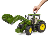 Green John Deere 7R 350 farm toy tractor with front loader and hand using roof steering