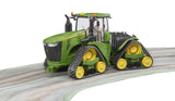 John Deere 9620RX tractor toy positioned on a curved surface showing crawler tracks and enclosed cab