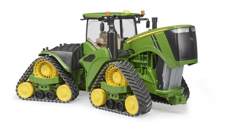 John Deere 9620RX tractor toy in green and yellow with enclosed cab, open engine hood, and four crawler track units on a white background