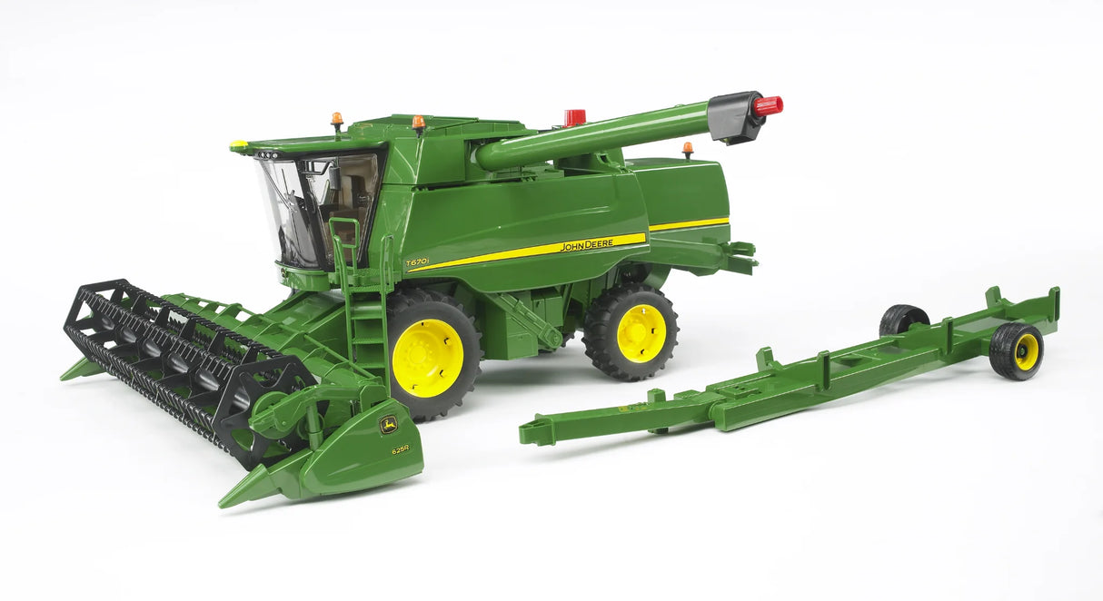 John Deere T670i combine harvester toy with front cutting header attached and separate green header trailer