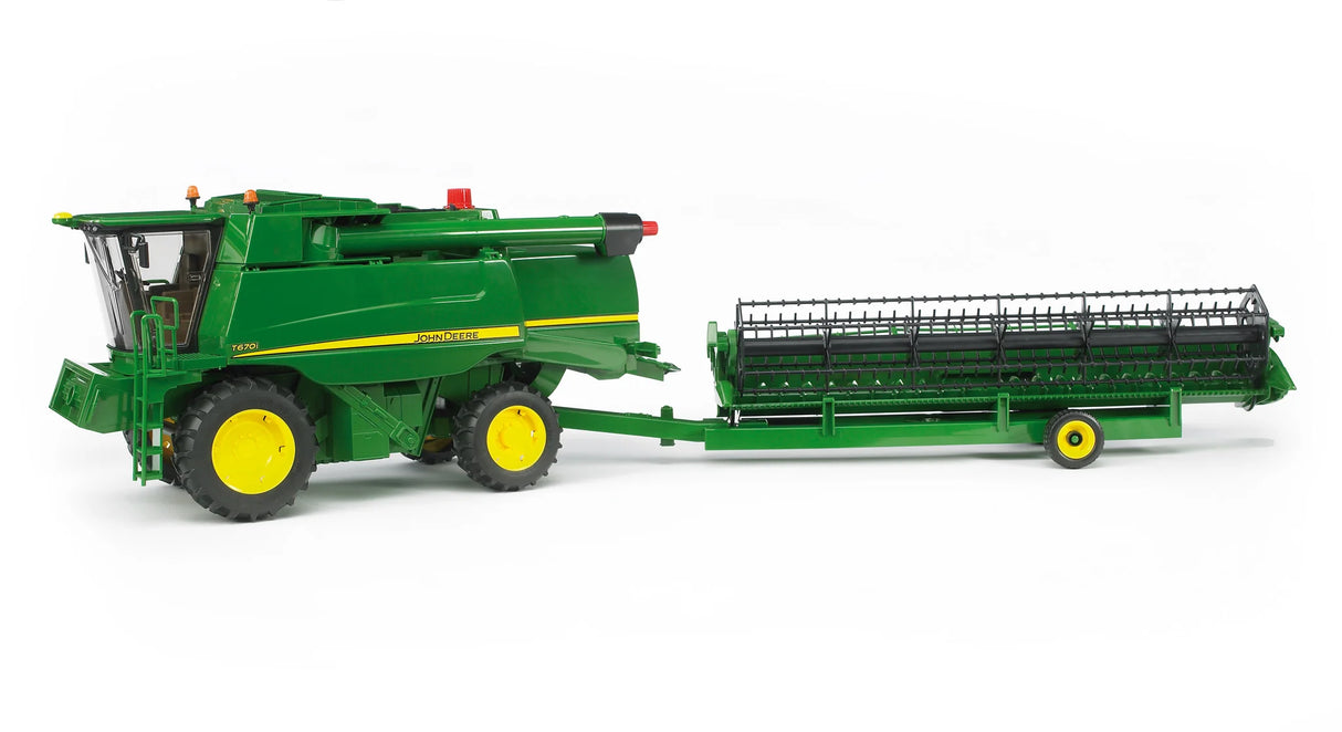 John Deere T670i combine harvester toy towing the long cutting header on its green transport trailer
