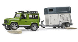 Bruder 1:16 Land Rover Defender farm toy towing the horse trailer over uneven ground