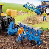 A toy Lemken plough attached to a tractor in a farm play scene with figures working nearby.