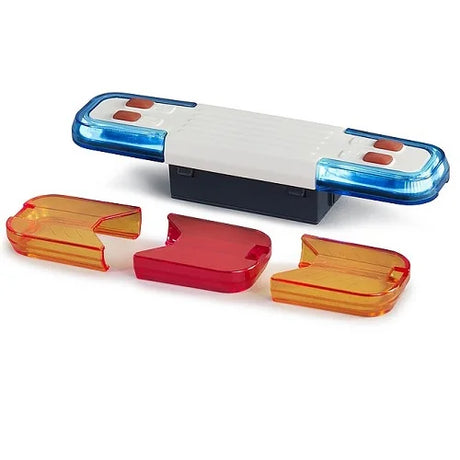 A toy light and sound module with a blue and white light bar and three loose coloured caps placed in front.