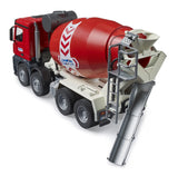 Rear view of Bruder Mercedes Benz Arocs cement mixer truck with extended grey discharge chute, red mixer drum, ladder, and rear wheels
