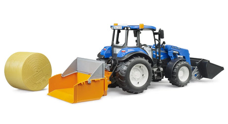 Blue farm toy tractor beside orange dump box, forks and round bale