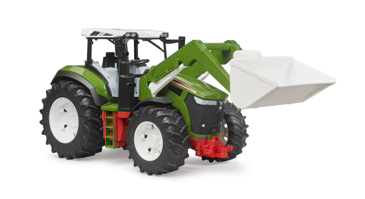 Bruder Roadmax tractor with green body, raised white front loader bucket, red chassis details and large tread tyres on a white background.