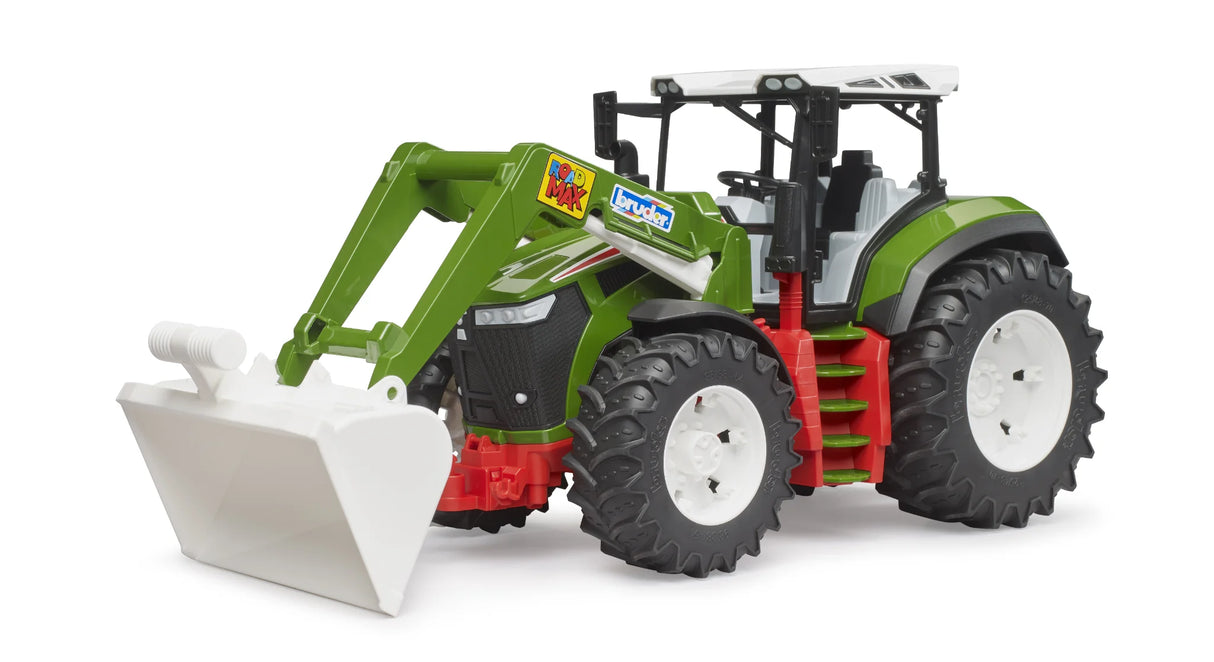 Bruder Roadmax tractor with green body, white roof, white front loader bucket, black frame and large tread tyres on a white background.