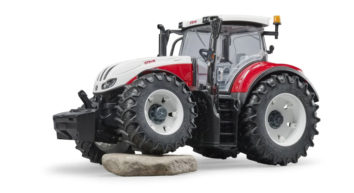 Bruder Steyr 6300 Terrus CVT tractor positioned on uneven surface showing off road tyres and oscillating front axle
