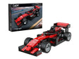 CaDA Triumph Legend Formula racecar displayed beside retail box showing racing artwork and CaDA logo