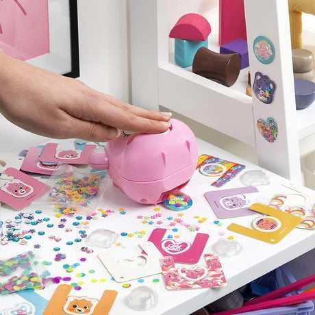 Hand pressing Care Bears 3D Sticker Maker with stickers on table – Ireland. 