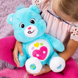 Care Bears Always Here Bear blue plush displayed in a lifestyle photograph.