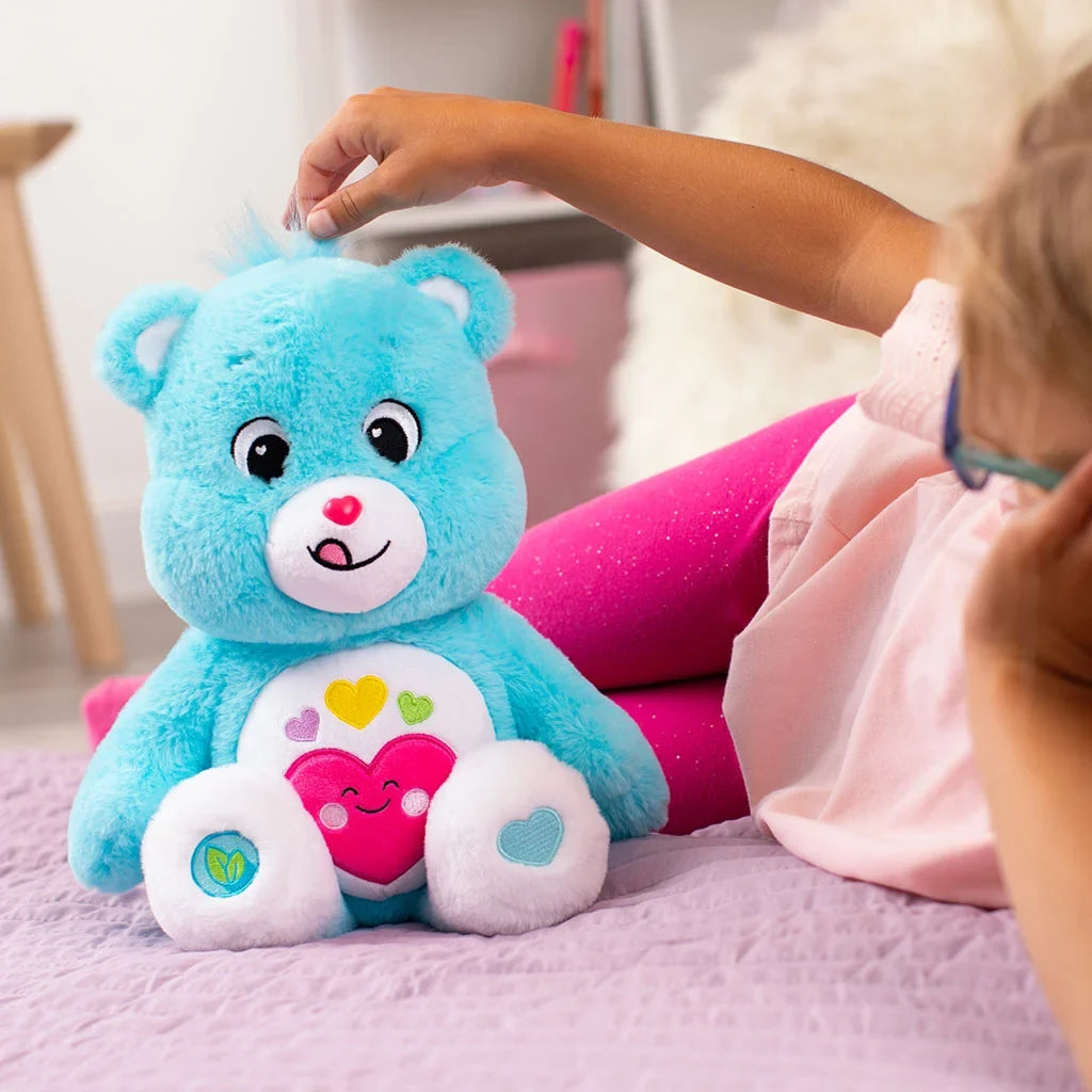 Care Bears Always Here Bear plush in a lifestyle setting, showing its blue and white colouring.