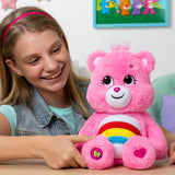 Child playing with Care Bears Cheer Bear eco-friendly 14″ plush toy with rainbow belly badge in Ireland.