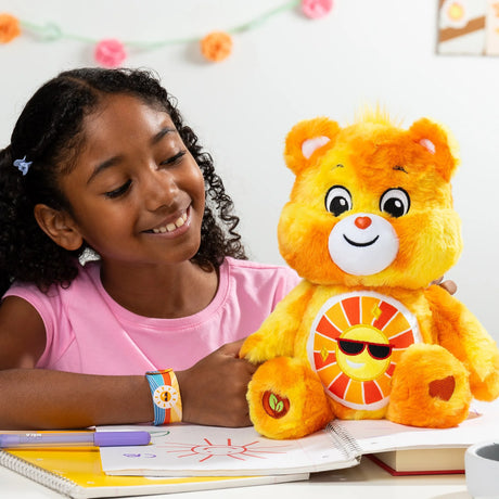 Child hugging Care Bears Color Splash Funshine Bear plush highlighting sunny yellow and orange fur in Ireland.