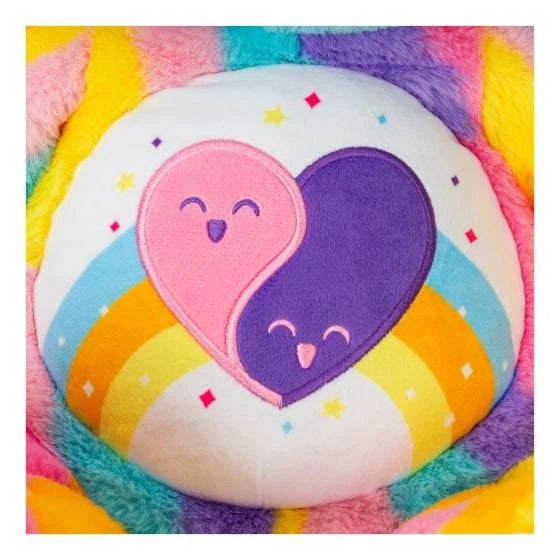 Close-up of the Care Bears Friends Forever Bear embroidered tummy badge showing two interlocking pink and purple smiling hearts on a white and rainbow striped background with star details