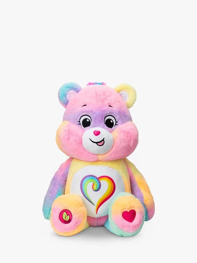 Care Bears Jumbo Plush Togetherness Bear seated front view, showing pastel rainbow multicolour fur, embroidered face, rainbow heart tummy badge and leaf and heart foot details
