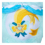 Close-up of Care Bears Kindness Keepers Wish Bear belly badge featuring a yellow shooting star, turquoise decorative bow, embroidered star ornament and gold accents on a white background.