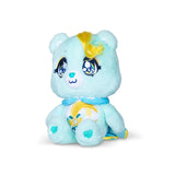 Care Bears Kindness Keepers Wish Bear turquoise plush seated at an angle with large blue eyes, yellow curled hair, blue collar, heart shaped paw details and shooting star belly badge.