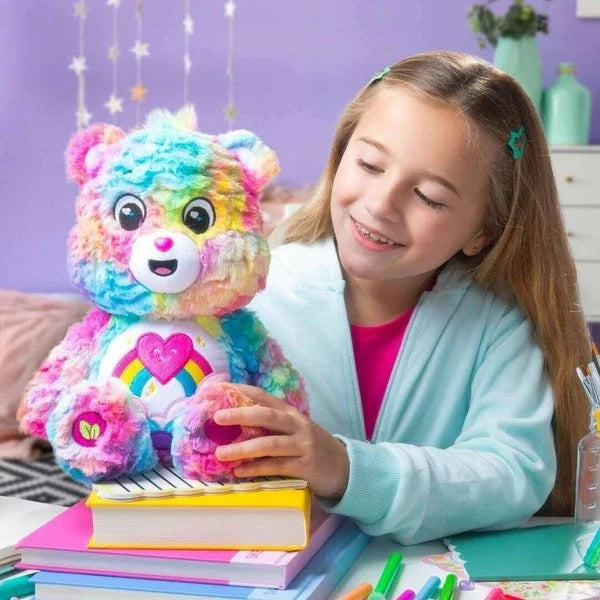 Child sitting at a desk holding the Care Bears Colours of Caring Bear medium plush, showing the toy's size relative to a school-age child