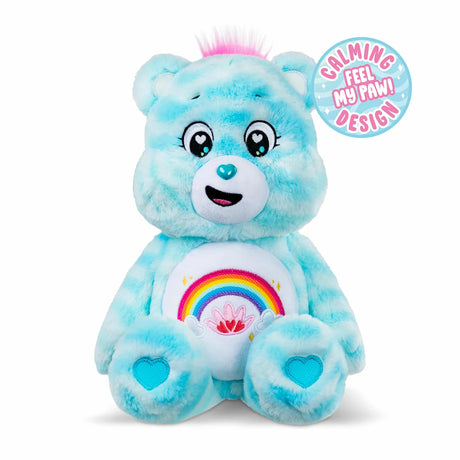 Care Bears 35cm Sweet Serenity Bear blue plush with pink hair tuft, rainbow belly badge, turquoise heart paw pads and calming sensory design graphic on white background.