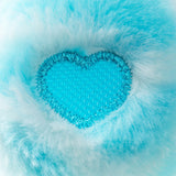 Close-up of Sweet Serenity Bear's turquoise heart shaped textured paw pad surrounded by soft blue plush fur, showing the raised sensory surface.