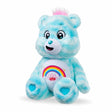 Care Bears 35cm Sweet Serenity Bear seated at an angle on a white background, showing blue plush fur, pink hair tuft, rainbow belly badge and turquoise heart paw pads.