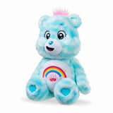 Care Bears 35cm Sweet Serenity Bear seated at an angle on a white background, showing blue plush fur, pink hair tuft, rainbow belly badge and turquoise heart paw pads.