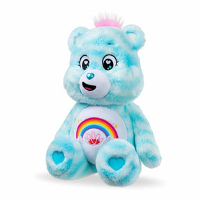 Care Bears 35cm Sweet Serenity Bear seated at an angle on a white background, showing blue plush fur, pink hair tuft, rainbow belly badge and turquoise heart paw pads.
