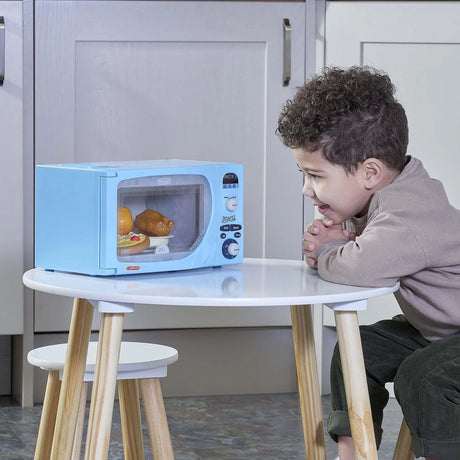 Child playing with Casdon DeLonghi microwave toy at table – Ireland