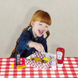 Child with open Casdon Heinz fish and chips takeaway box, ketchup bottle, vinegar bottle, salt shaker and fork