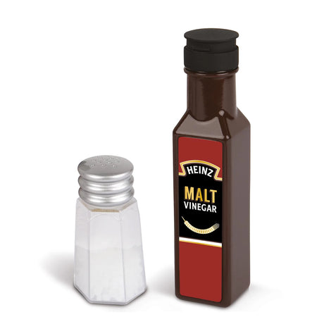 Toy salt shaker beside Heinz malt vinegar bottle