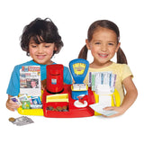 Two children playing with Casdon Post Office set featuring stamps, letters, coins and bright red counter