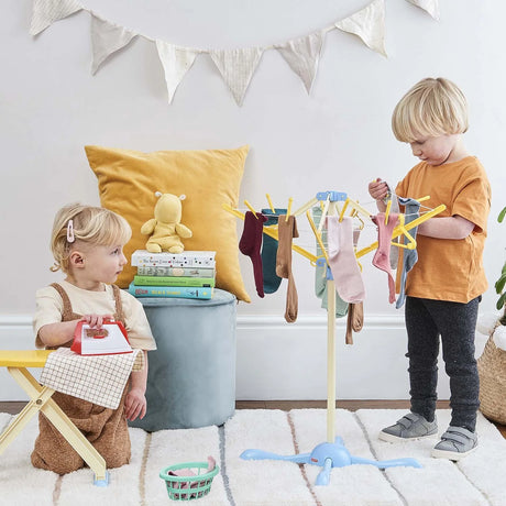Children using Casdon Wash Day Set to hang socks on rotary clothes line indoors – Ireland