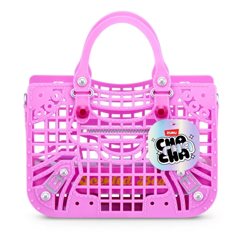 Bright pink Cha Cha Cha purse with top handles, a lattice front, zip detail and hanging brand tag. 