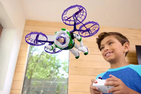 Child holding the remote controller while Buzz Lightyear flies indoors with four purple propeller guards