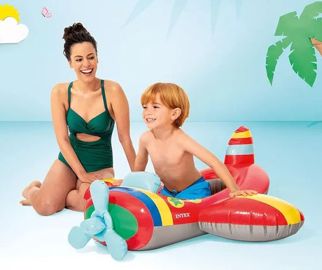 Smiling child playing in Intex Airplane Pool Cruiser float with adult nearby, Ireland