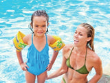 Child wearing Intex Pool School Step 3 armbands in a swimming pool with adult supervision in Ireland