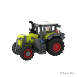 Front left three quarter view of the BRIXIES Plus CLAAS AXION 9450 showing the front weight, headlights, green bonnet, cab and large rear wheel