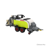 BRIXIES Plus CLAAS QUADRANT 5300 FC square baler viewed from the front left showing the drawbar, pickup section, twin wheels and lime green side panels