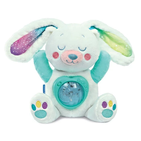 Baby Clementoni Arctic Bunny white plush toy with closed embroidered eyes, rainbow coloured ears, turquoise paws and circular light projector on its tummy.