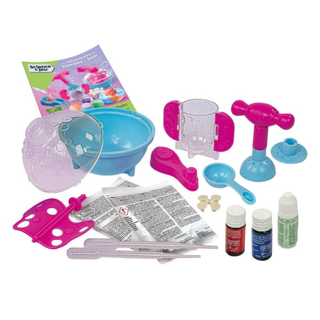 Clementoni Beautiful Bath Bombs kit contents arranged on a white background, including a blue mixing bowl, transparent container, pink and turquoise moulding equipment, measuring spoon, bottles, pipettes, ingredient packets and instruction booklet.
