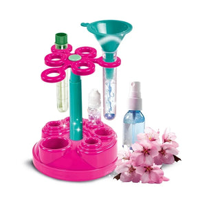 Clementoni Mini Perfume Lab stand with test tubes, funnel, bottles and pink flowers.