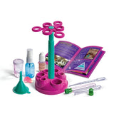 Clementoni Mini Perfume Lab parts with bottles, tubes, funnel, pipette, measuring container and open instruction booklet.