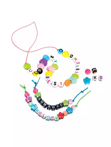 Colourful friendship bracelets made with pastel beads, flower shaped beads, smiley face beads and alphabet beads spelling messages, displayed with pink and green cords on a white background.
