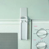 Clippasafe Microwave Oven Lock fitted to a white microwave door, showing press to lock mechanism secured between door and frame