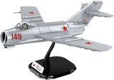 COBI MiG-15 Fagot model with pilot figure on black display stand against a white background