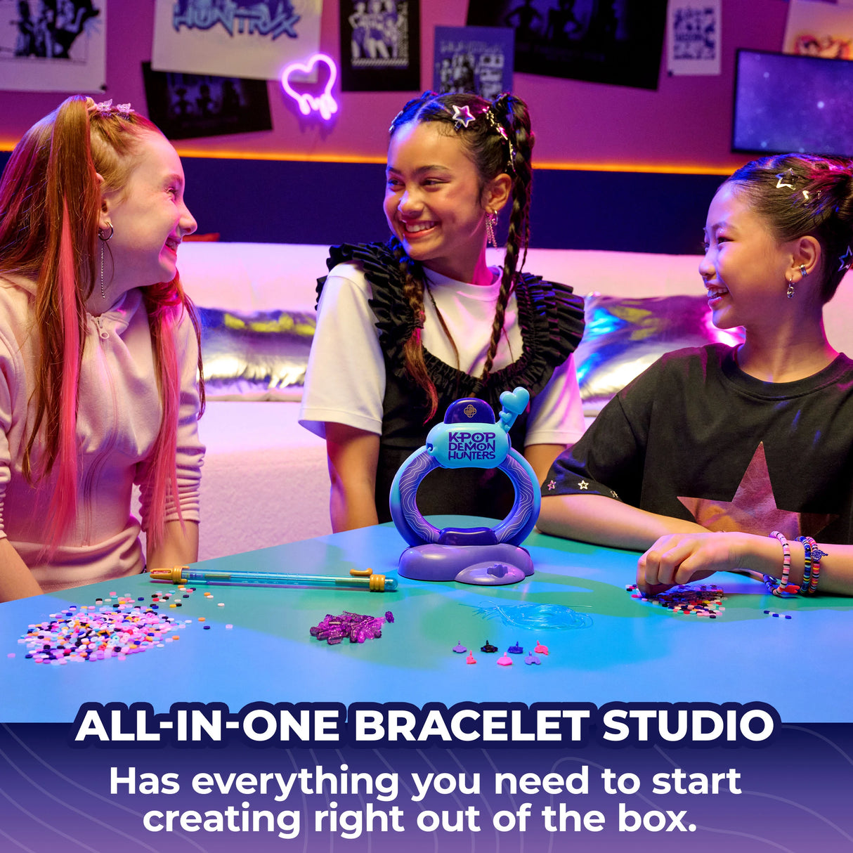 Three children around the Cool Maker KPop Demon Hunters bracelet studio with loose beads on the table