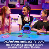 Three children around the Cool Maker KPop Demon Hunters bracelet studio with loose beads on the table
